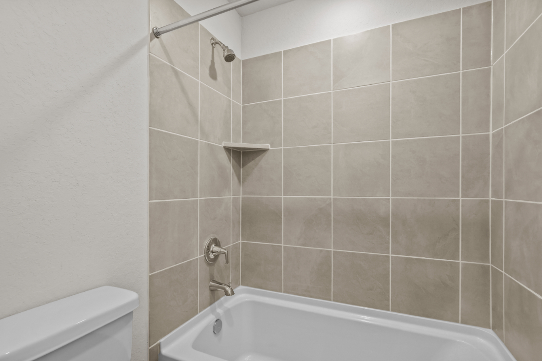 A bathroom with a tile shower.