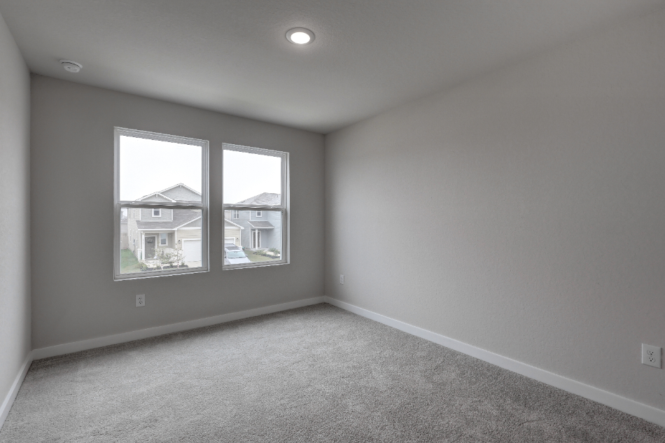 A room with a window and a carpet.