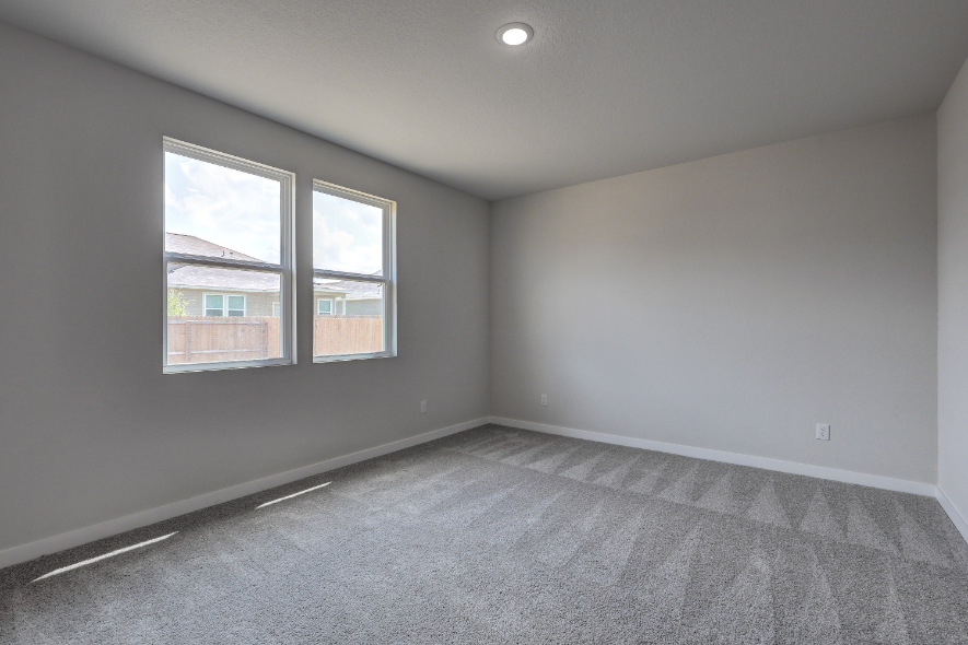 A room with a window and a carpet.