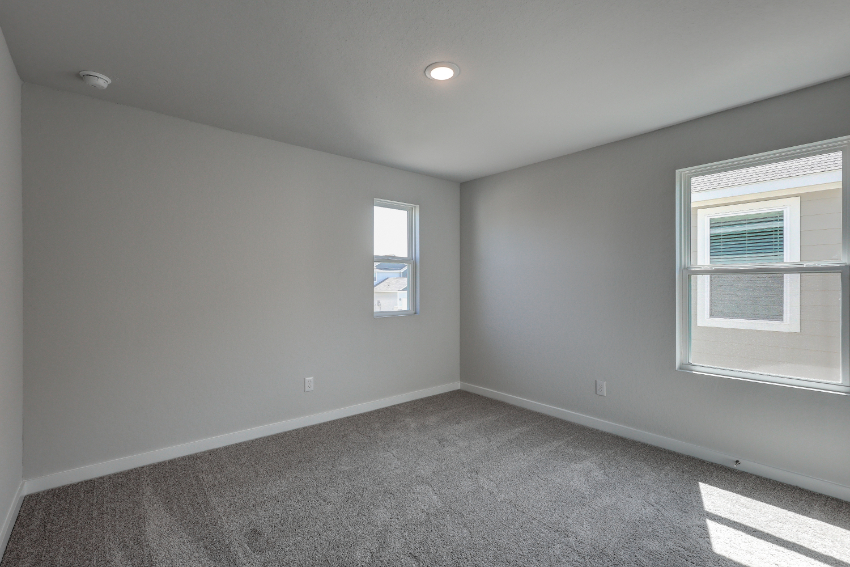 A room with windows and carpet.