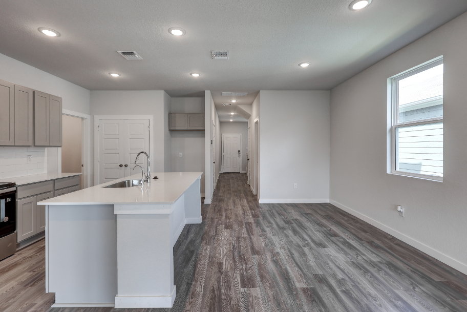 A kitchen with white cabinets.