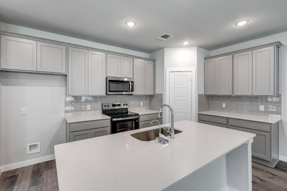 A kitchen with white cabinets.
