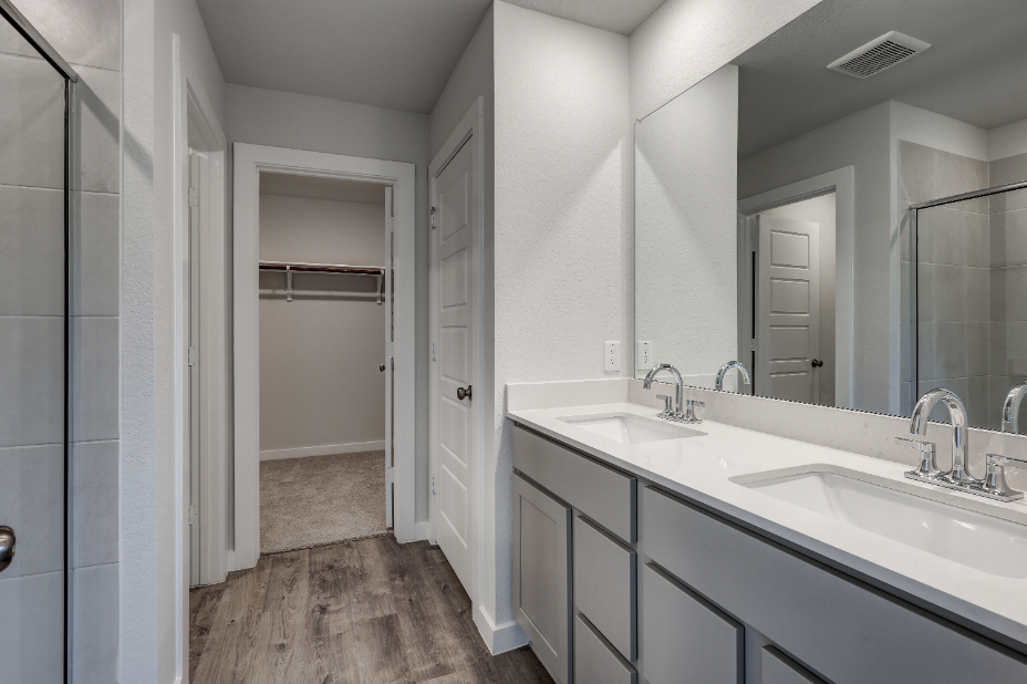A bathroom with a large mirror.