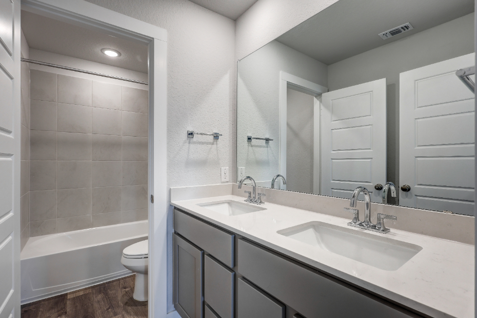 A bathroom with a tub sink and toilet.