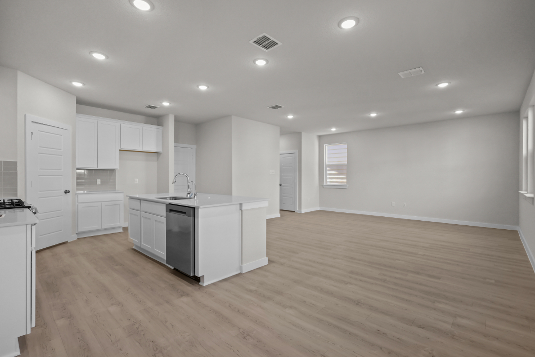 A kitchen with white cabinets.