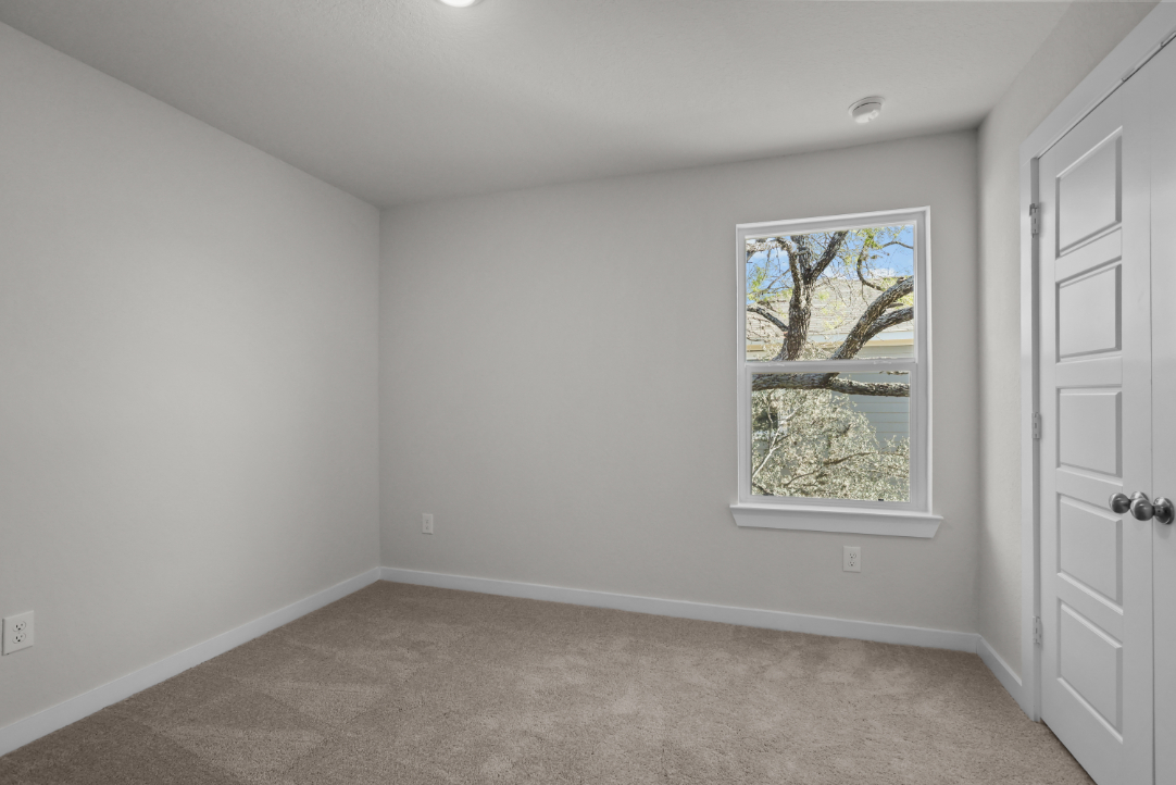 A room with a window and a door.