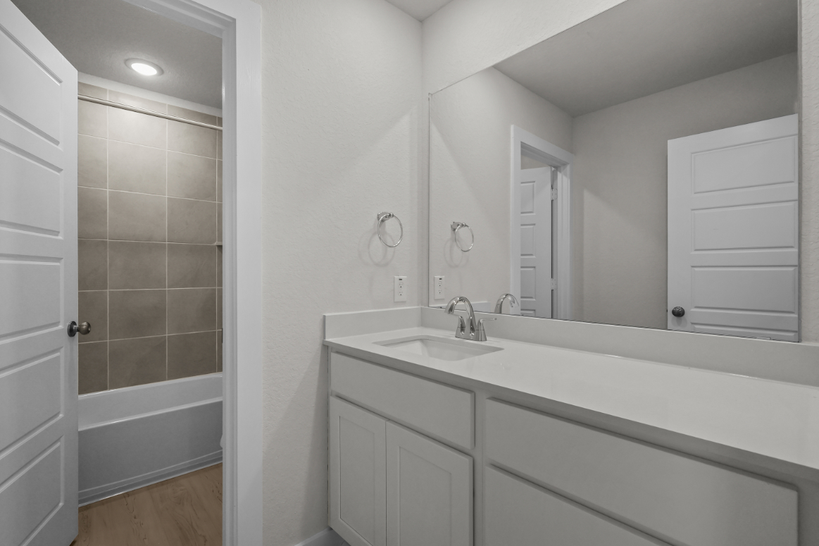 A bathroom with a sink and a bathtub.