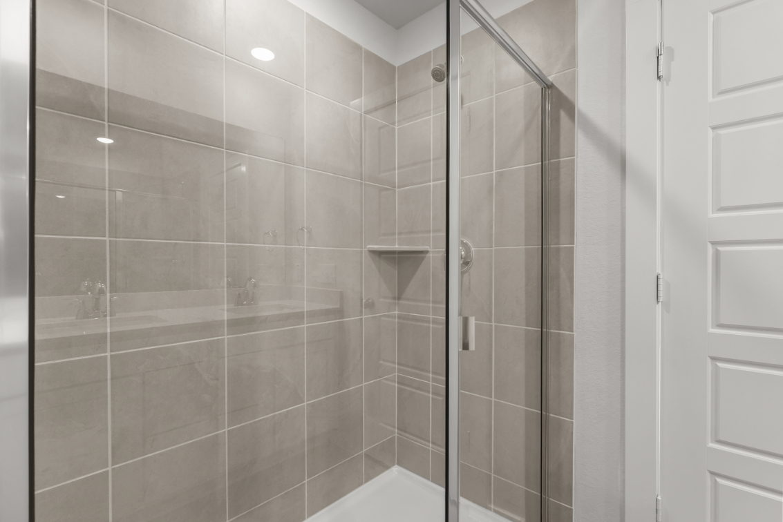 A shower with glass doors.