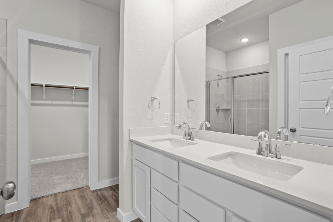 A bathroom with a large mirror.