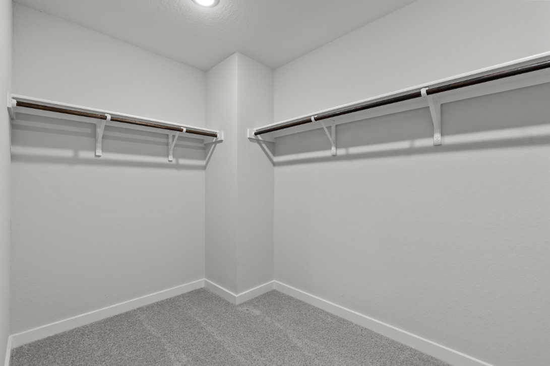 A white wall with a metal railing.