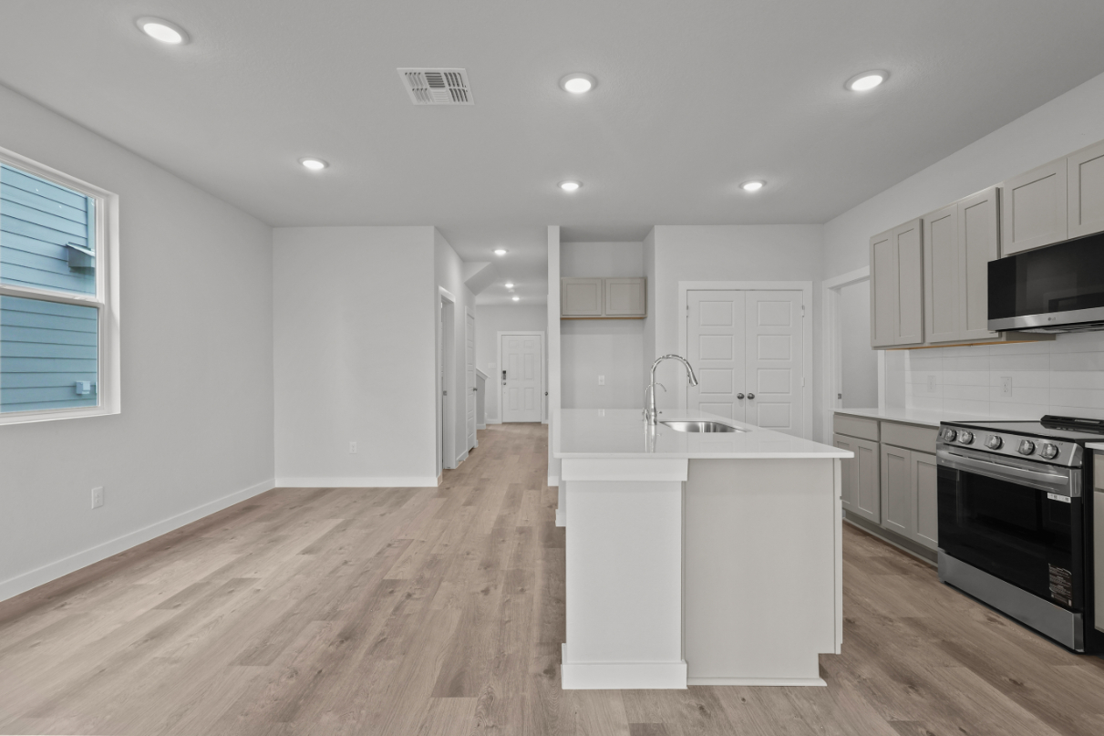 A kitchen with white cabinets.