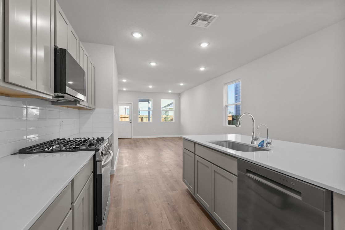 A kitchen with white cabinets.