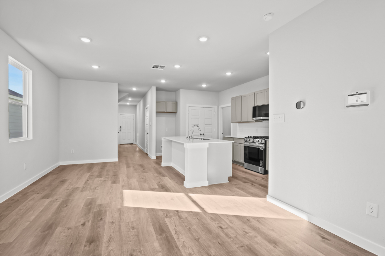 A kitchen with white cabinets.