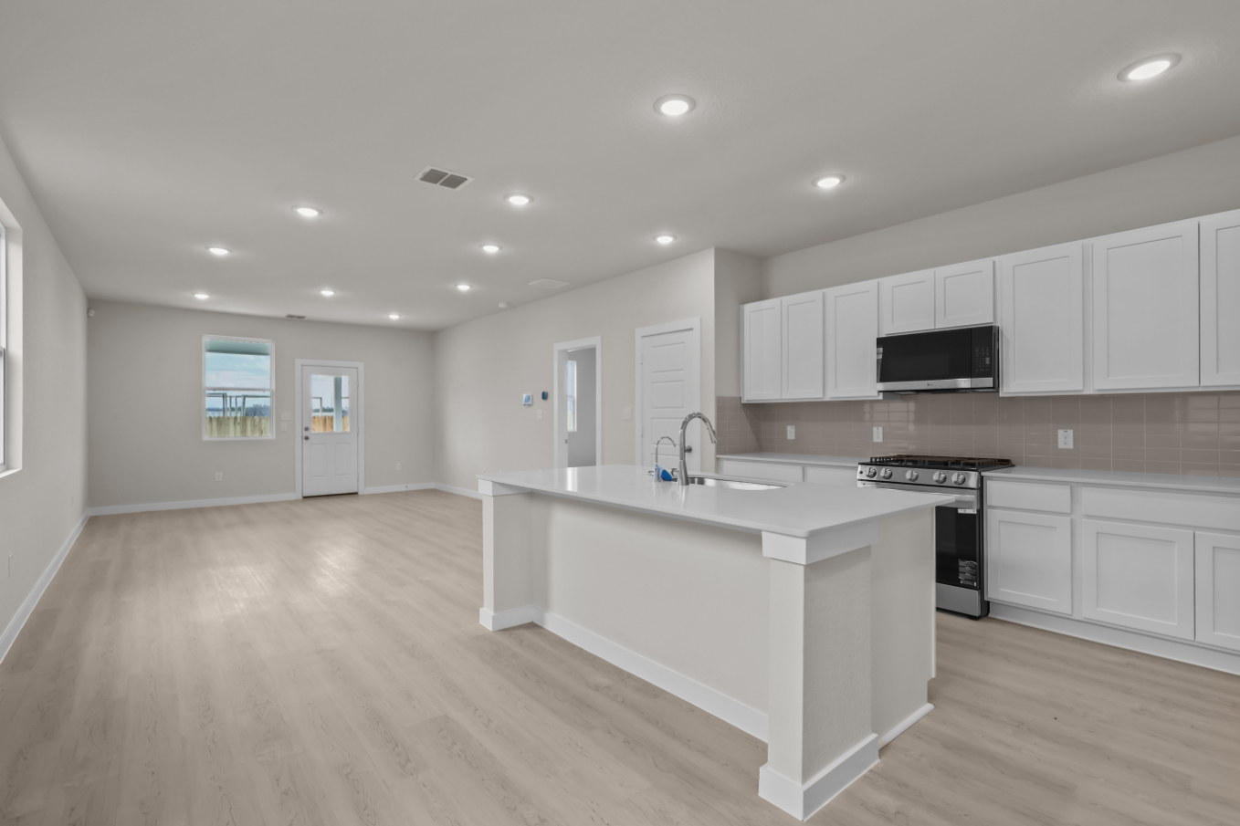 A kitchen with white cabinets.