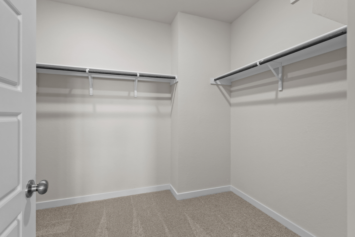 A white room with a metal railing.