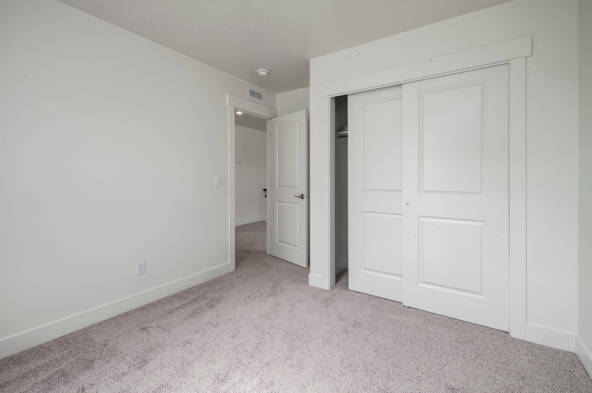 A hallway with white doors.