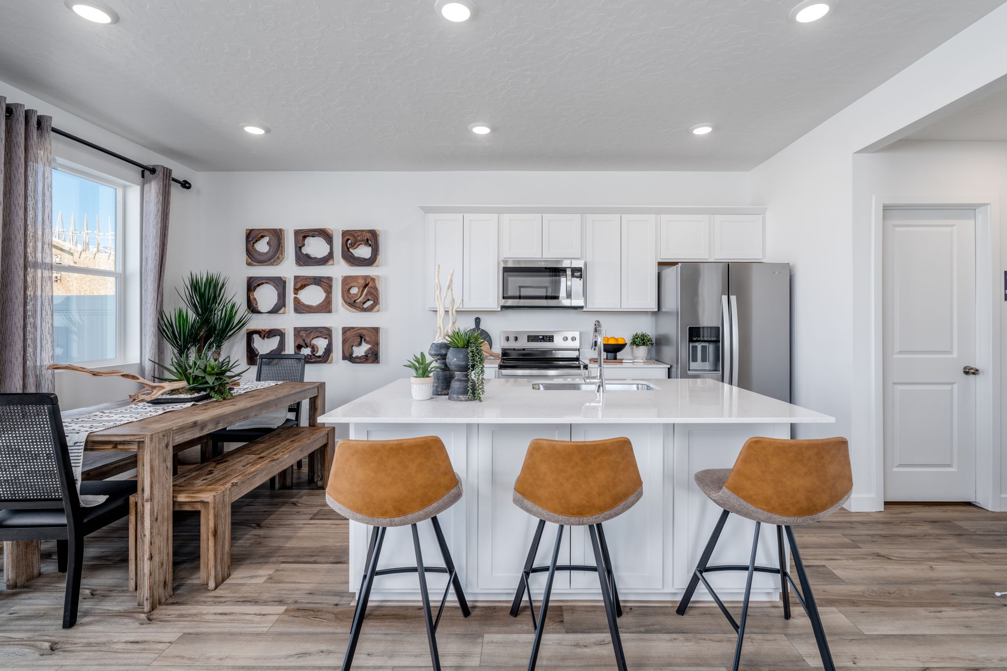A kitchen with a table and chairs.