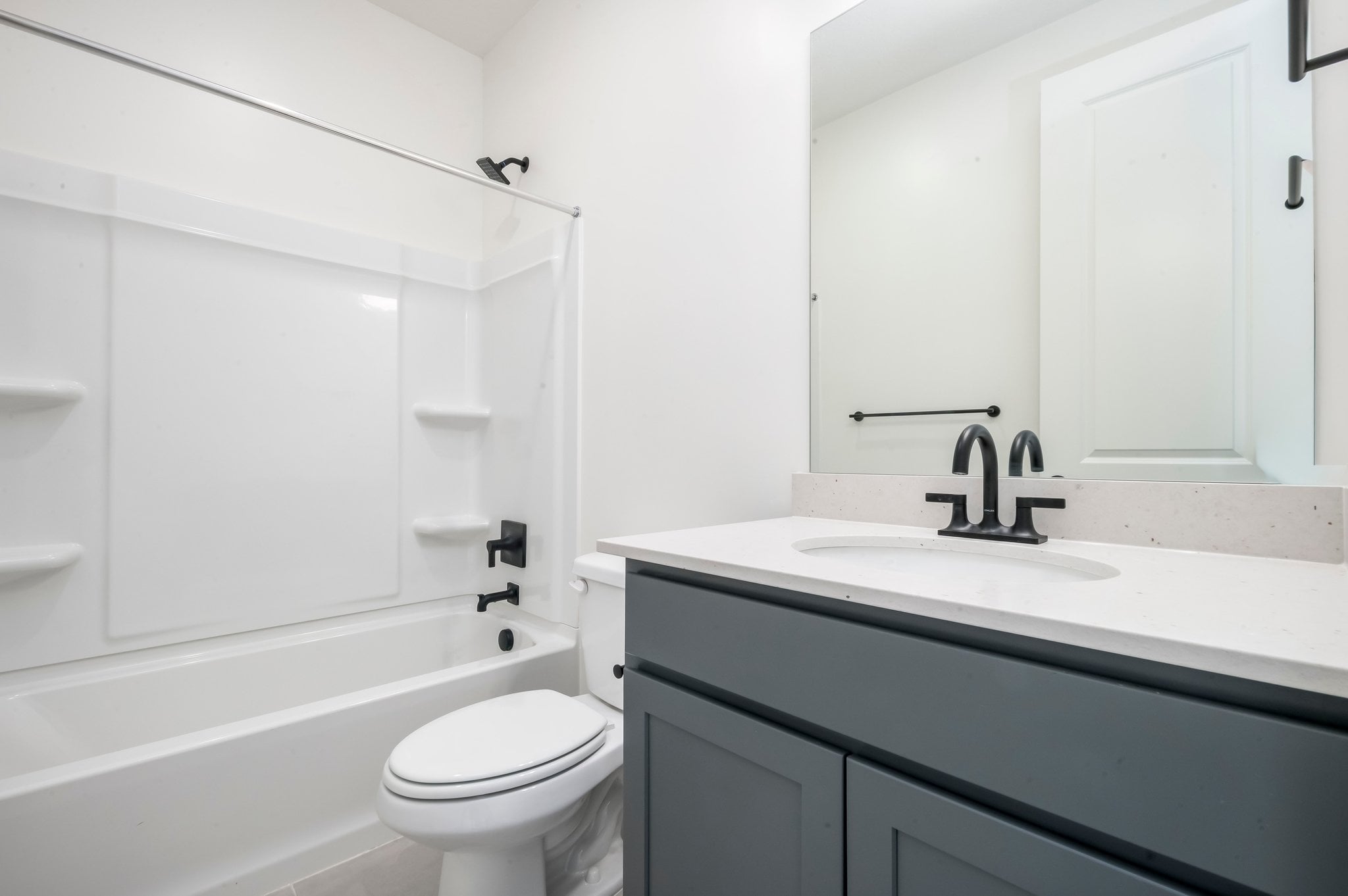 A bathroom with a sink toilet and bathtub.