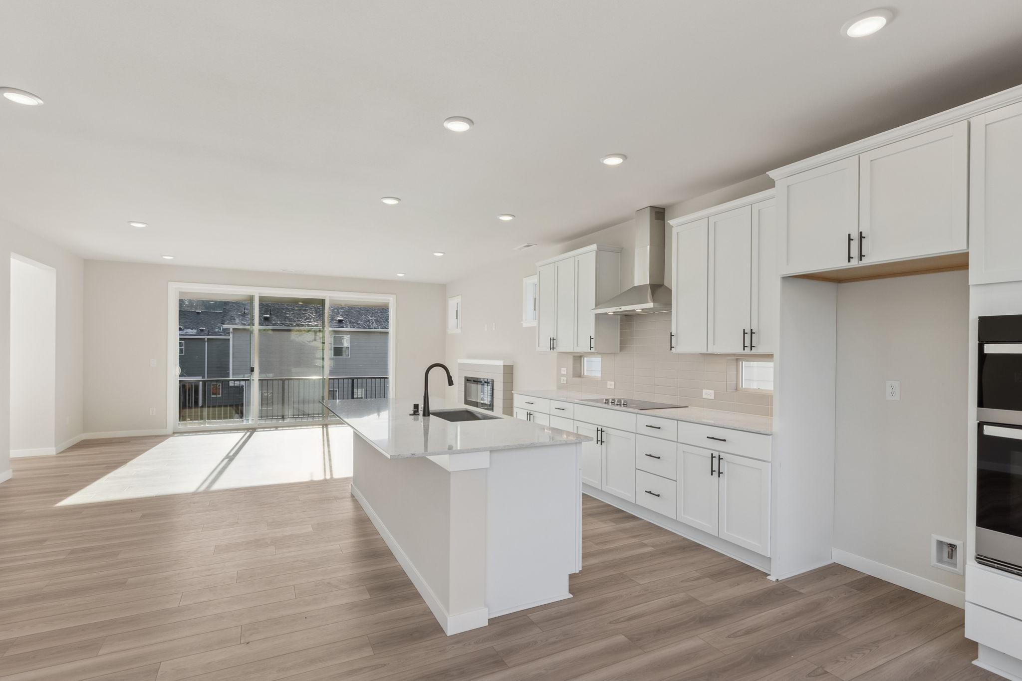 A kitchen with white cabinets.