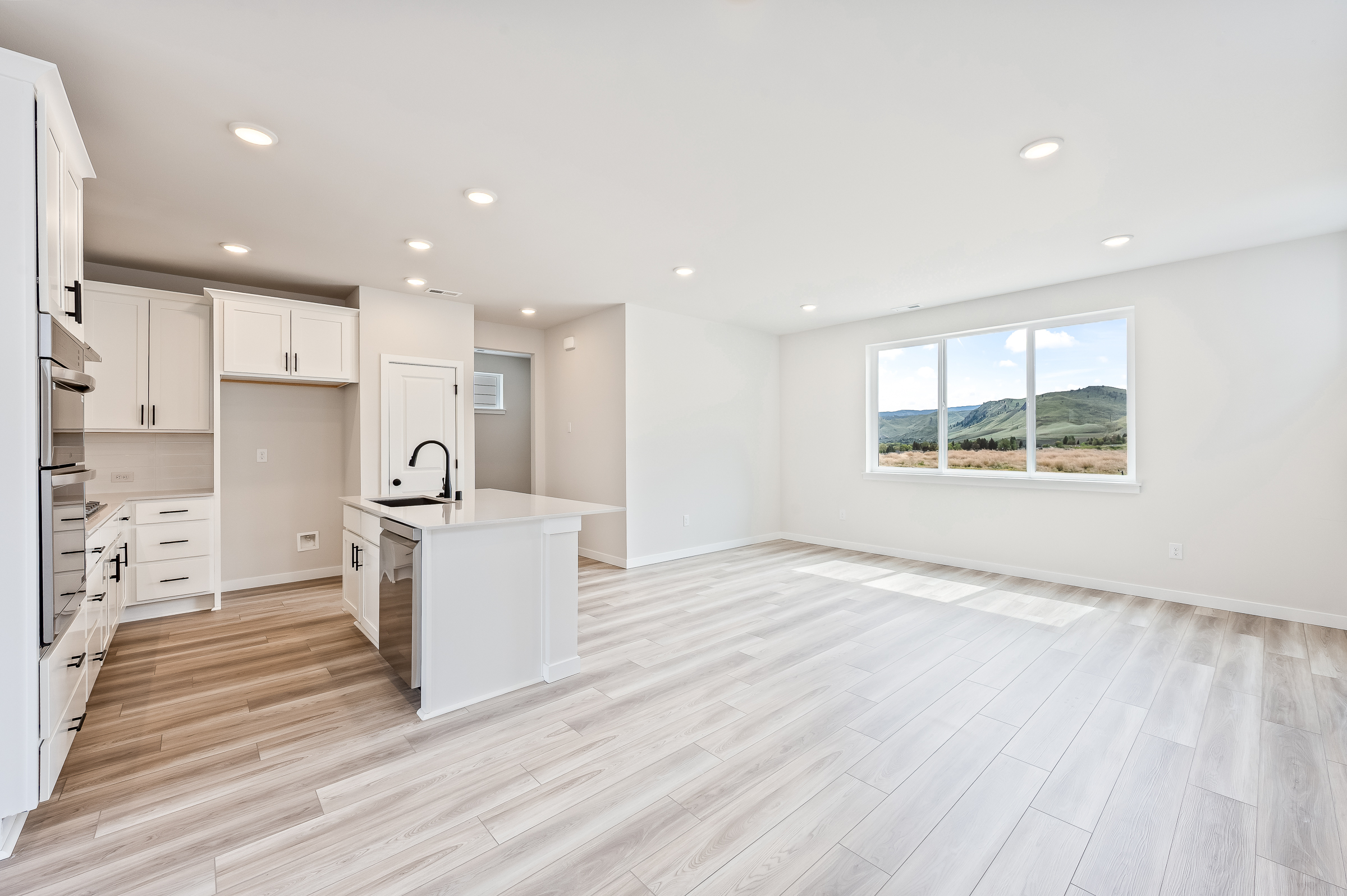 A kitchen with white cabinets.