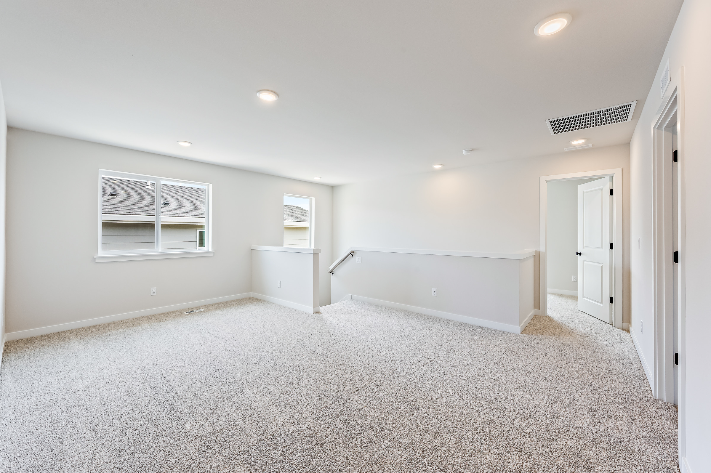 A room with white walls and a carpeted floor.