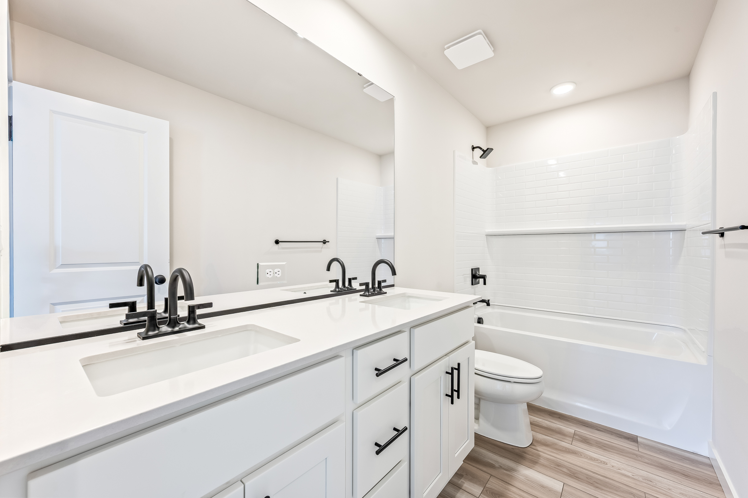 A bathroom with a tub sink and toilet.