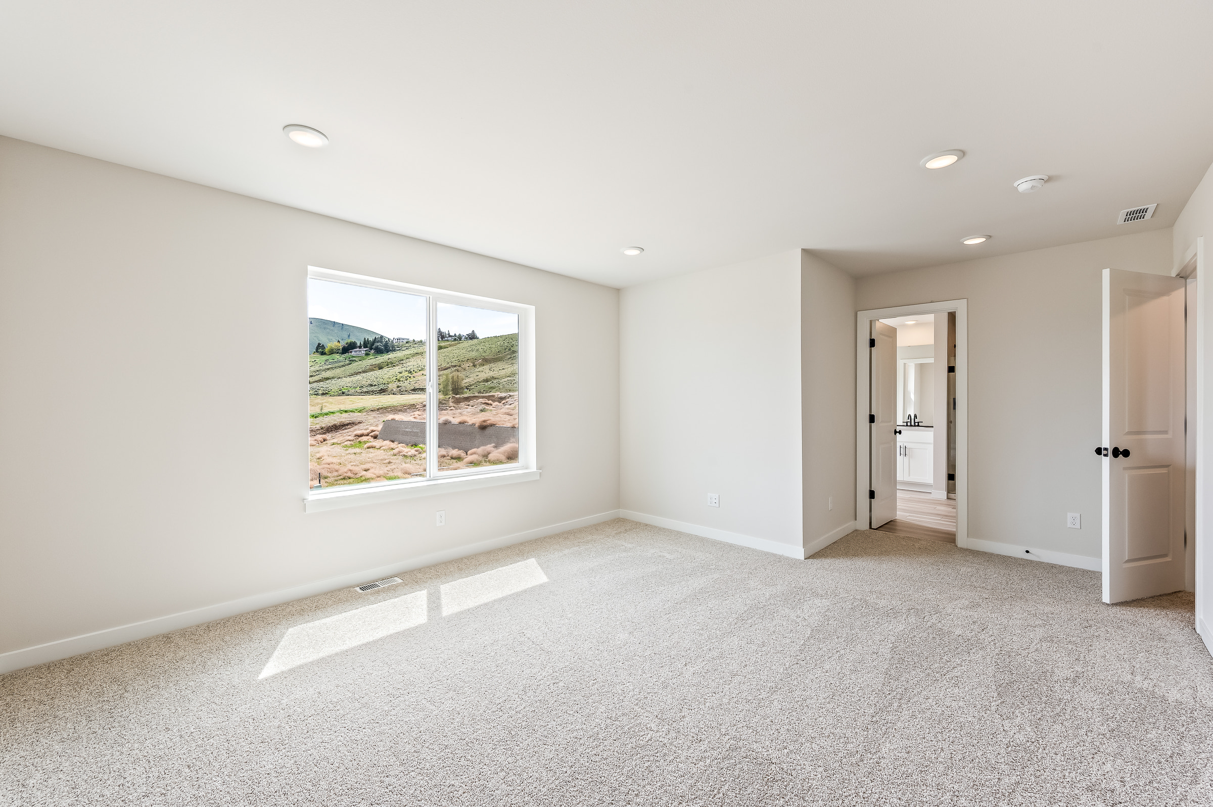 A room with a window and a door.