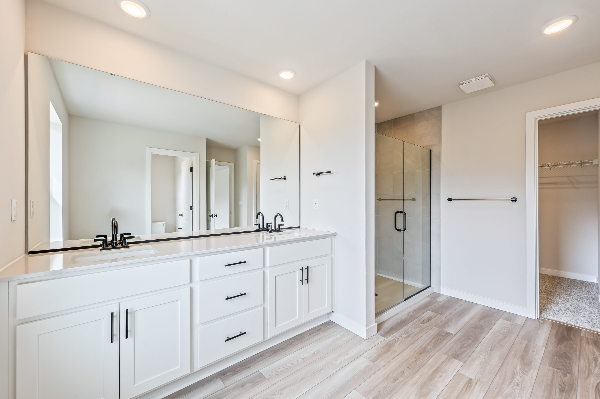 A bathroom with white cabinets.
