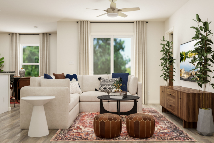 A living room with a white couch and a fan.