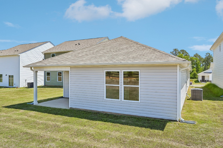 A small house with a grass yard.