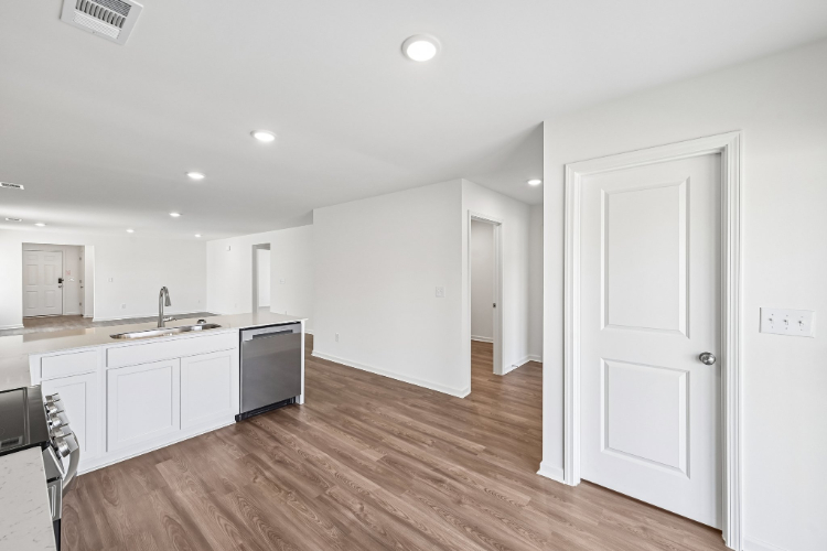 A kitchen with white cabinets.