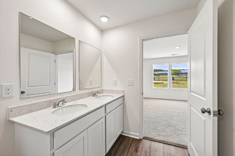 A bathroom with a sink and a mirror.