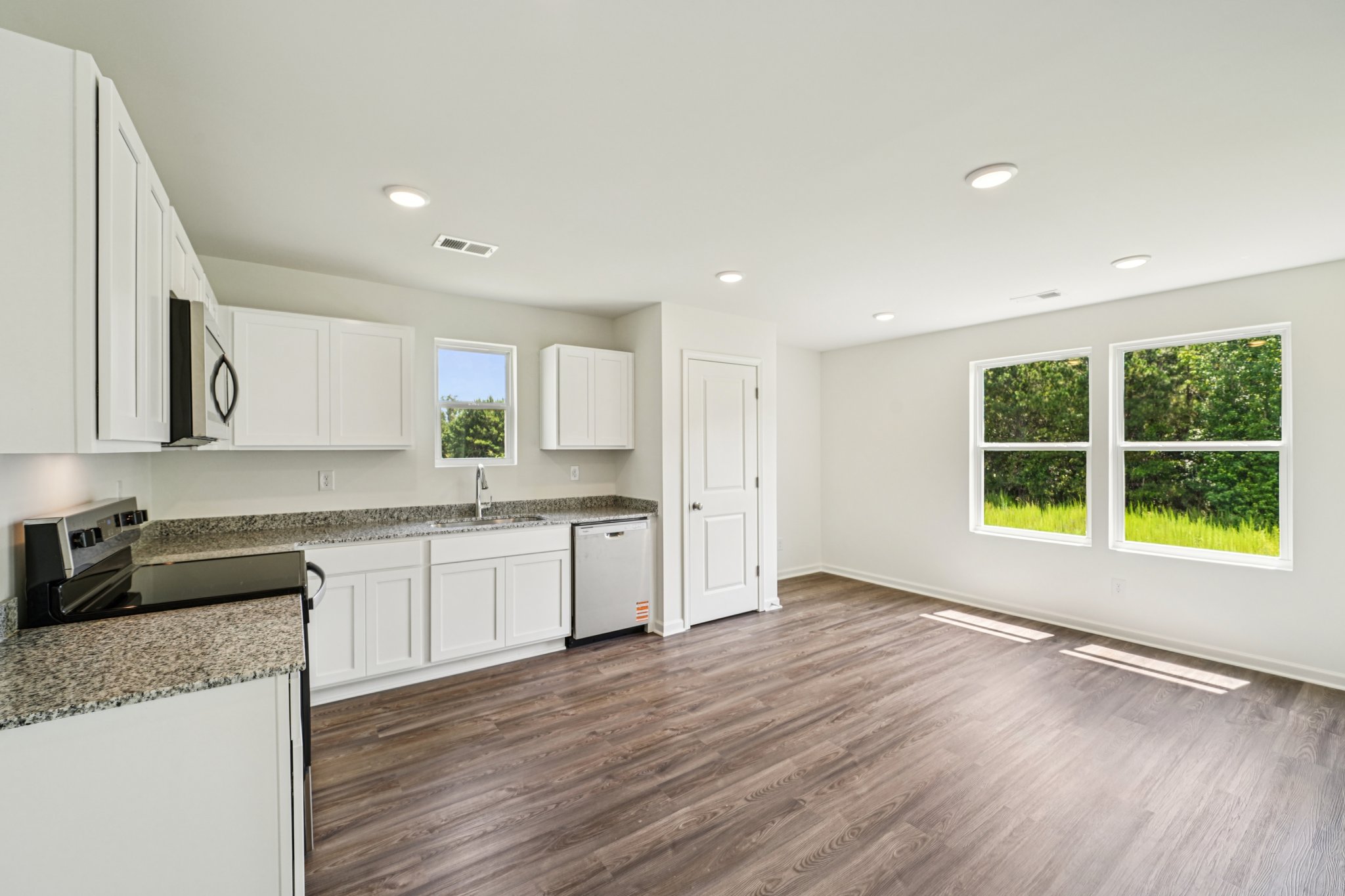 A kitchen with white cabinets.