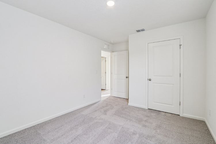 A hallway with white doors.