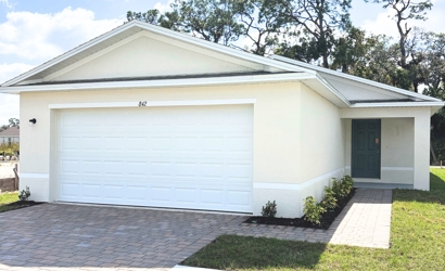 A white garage with a door.