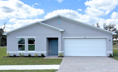 A white house with a driveway.