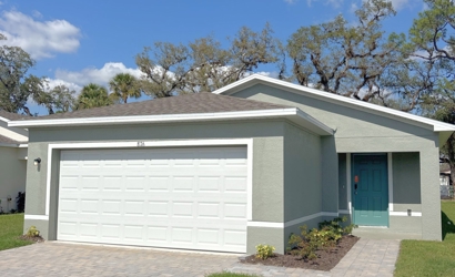 A white garage with a blue door.
