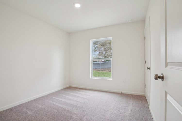 A room with a window and a door.