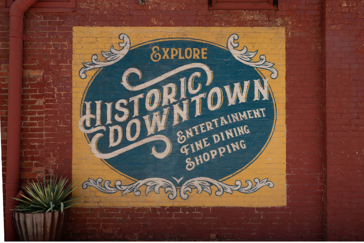 A sign on a brick wall.