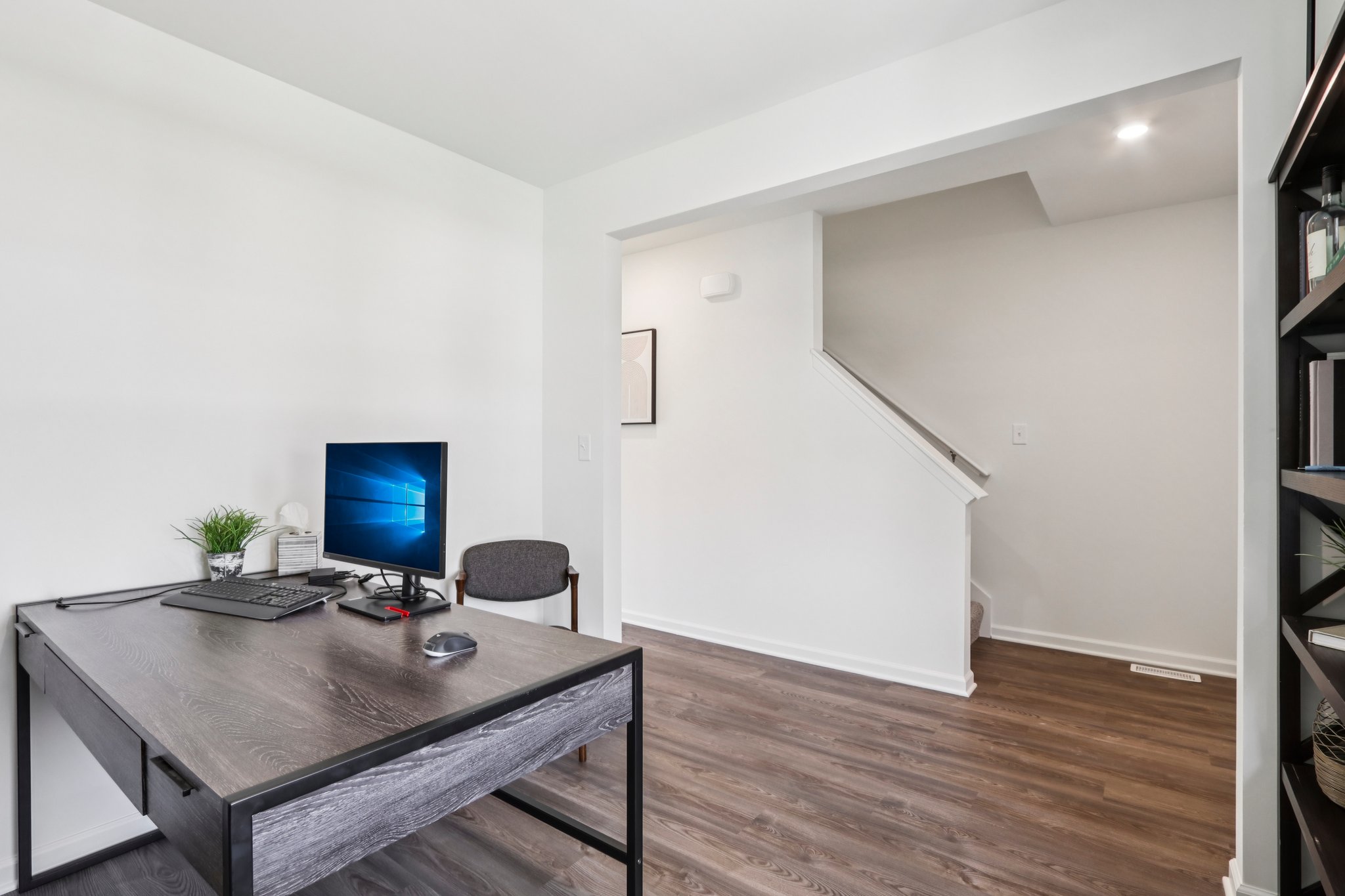 A room with a desk and a computer.