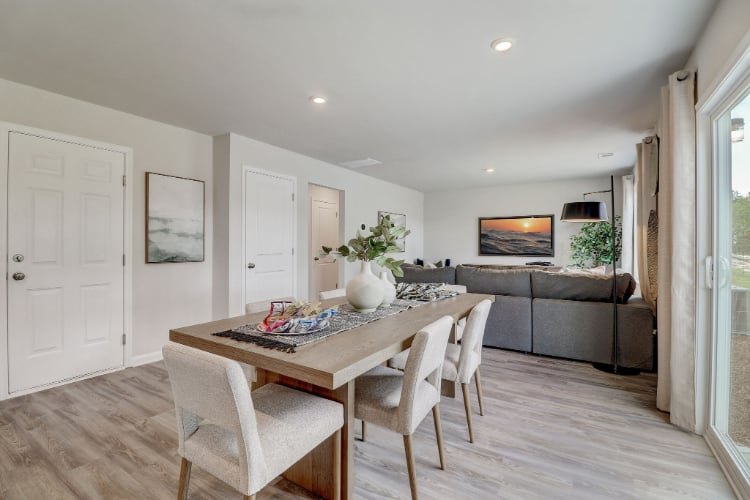 A dining room with a couch and chairs.