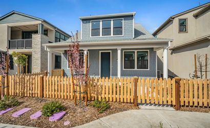 A fenced in yard with a house in the background.